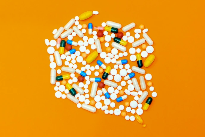 white and orange medication pill